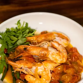 Oven-baked shrimp with cherry tomatoes and greens