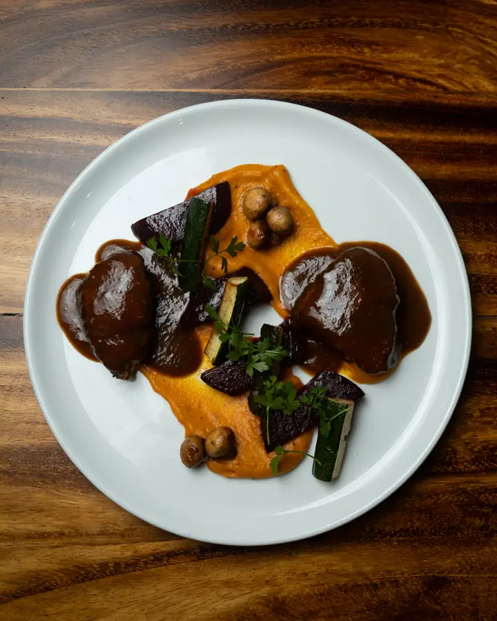 Chicken in tamarind sauce over carrot cream, with beetroot and zucchini